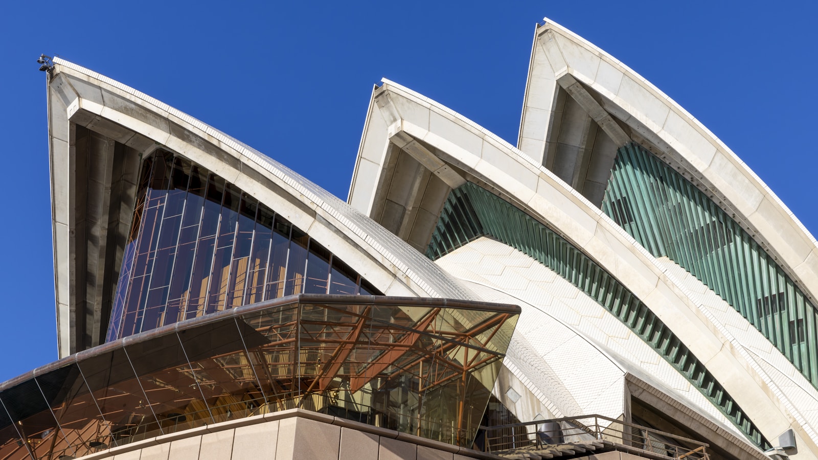 The sydney opera house under a bright blue sky.